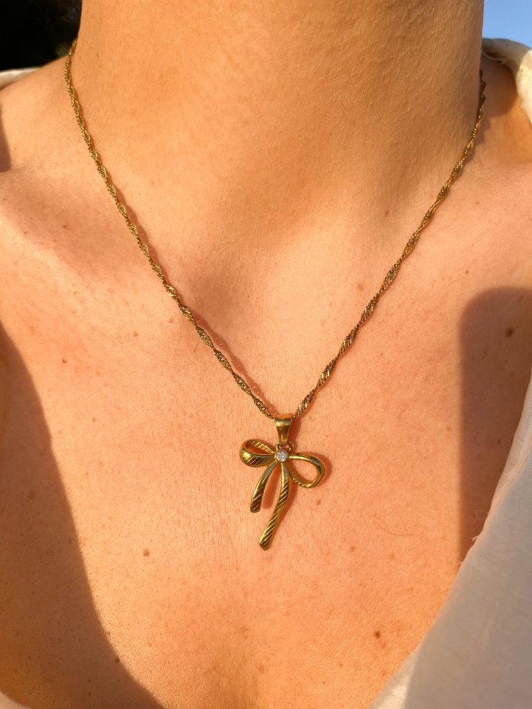 Collana con ciondolo a fiocco indossata - acciaio inossidabile oro